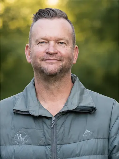 MetsonWorld Logistics driver in a branded jacket photographed outdoors