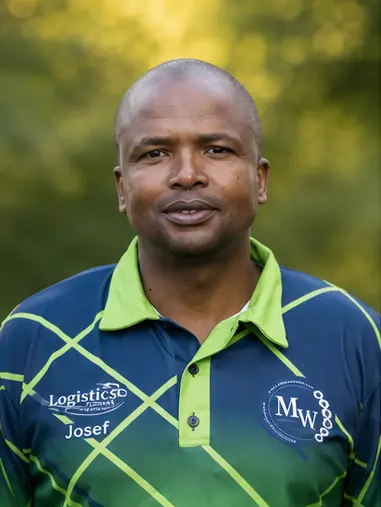 MetsonWorld Logistics driver in a branded blue and green shirt