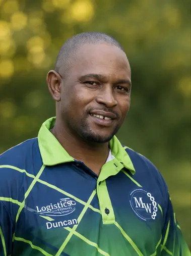 MetsonWorld Logistics driver in a branded blue and green shirt